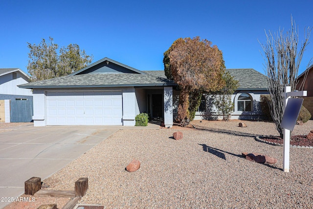 ranch-style house featuring an attached garage, stucco siding, concrete driveway, and roof with shingles