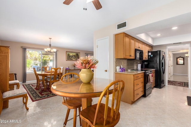 kitchen featuring backsplash, black appliances, ceiling fan with notable chandelier, hanging light fixtures, and light tile patterned floors