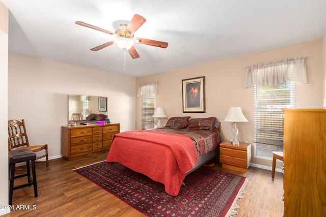 bedroom with ceiling fan and hardwood / wood-style flooring