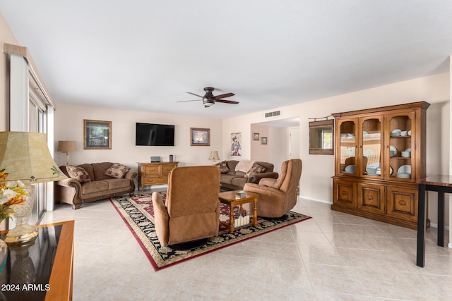 living room featuring light tile patterned floors and ceiling fan