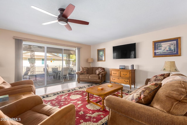 living room with tile patterned floors and ceiling fan