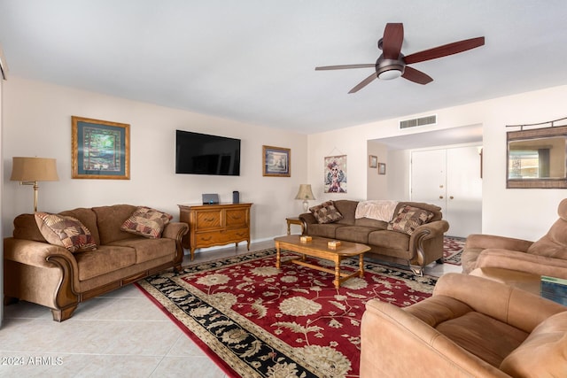 tiled living room with ceiling fan