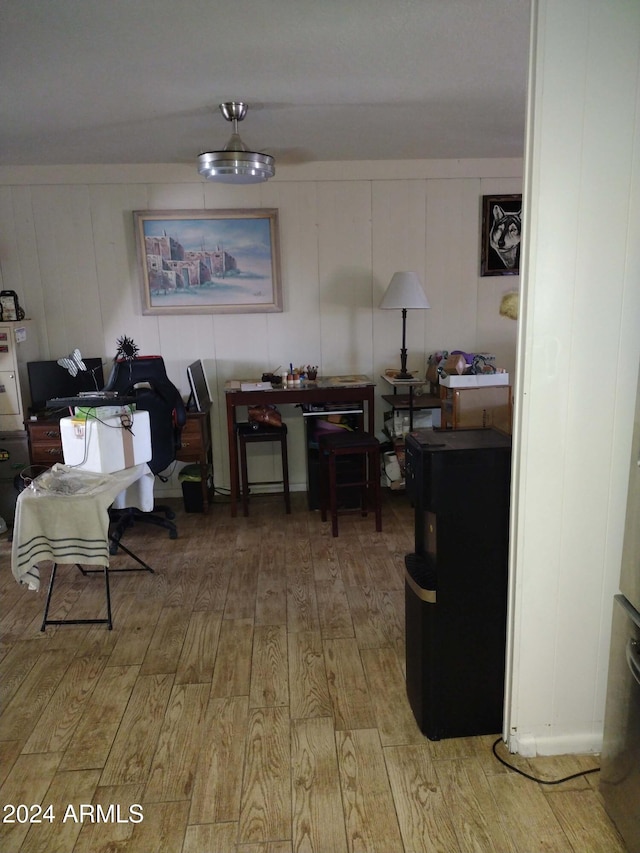 dining room with wooden walls and hardwood / wood-style floors