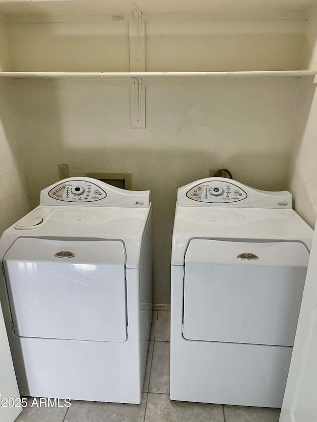 laundry area with light tile patterned floors and washing machine and dryer