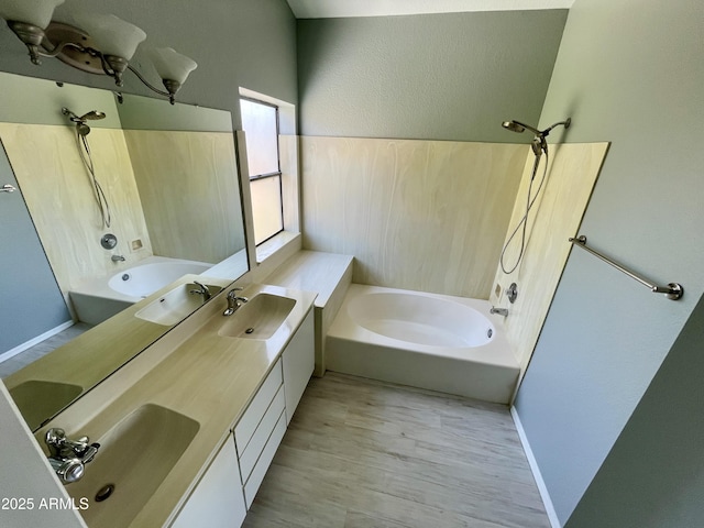 bathroom with bathing tub / shower combination, wood-type flooring, and vanity