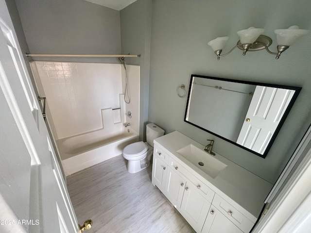 full bathroom featuring hardwood / wood-style flooring, vanity, toilet, and shower / bathing tub combination