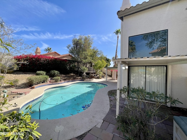 view of swimming pool featuring a patio area, fence, and a fenced in pool