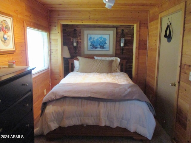 bedroom featuring wood walls