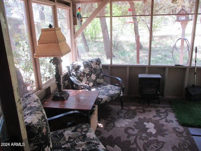 sunroom with a wealth of natural light and a wood stove