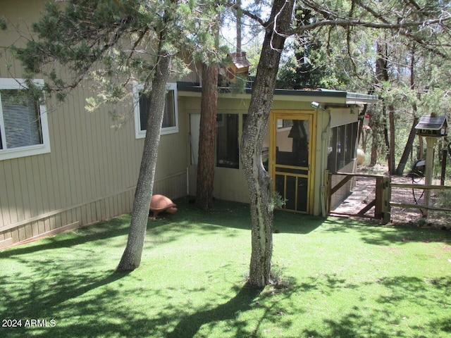 view of yard featuring a sunroom