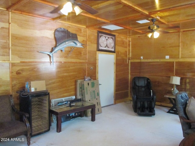 interior space featuring wood walls, wood ceiling, and a ceiling fan