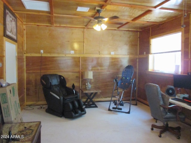 office space featuring concrete floors and wooden walls