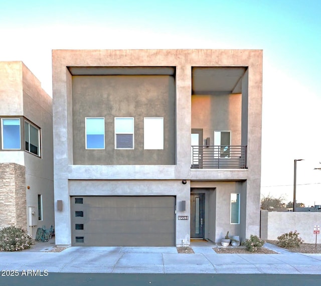 view of front of property with a balcony and a garage