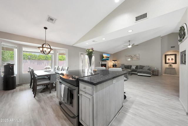 11446 N 109th St, Scottsdale, AZ 85259 - kitchen featuring stainless steel range with electric stovetop, dark countertops, light wood finished floors, a kitchen island, and a chandelier