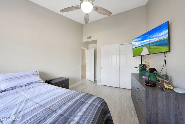 11446 N 109th St, Scottsdale, AZ 85259 - bedroom featuring a towering ceiling, light wood-type flooring, a closet, and a ceiling fan
