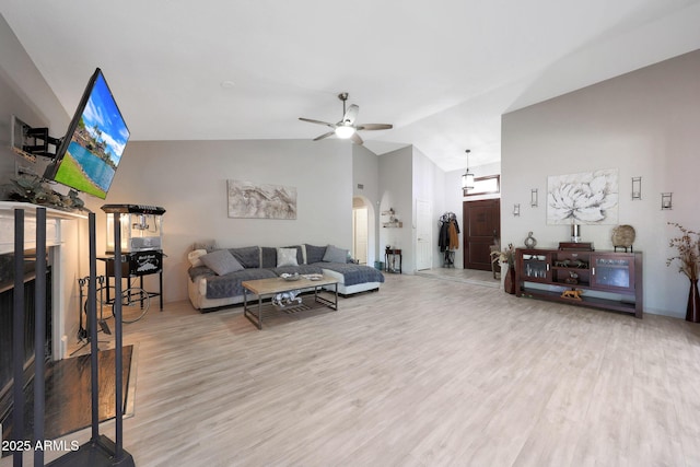 11446 N 109th St, Scottsdale, AZ 85259 - living room with wood finished floors, arched walkways, a ceiling fan, and high vaulted ceiling
