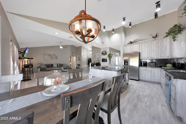11446 N 109th St, Scottsdale, AZ 85259 - dining space with ceiling fan, light wood-style floors, lofted ceiling, and a chandelier