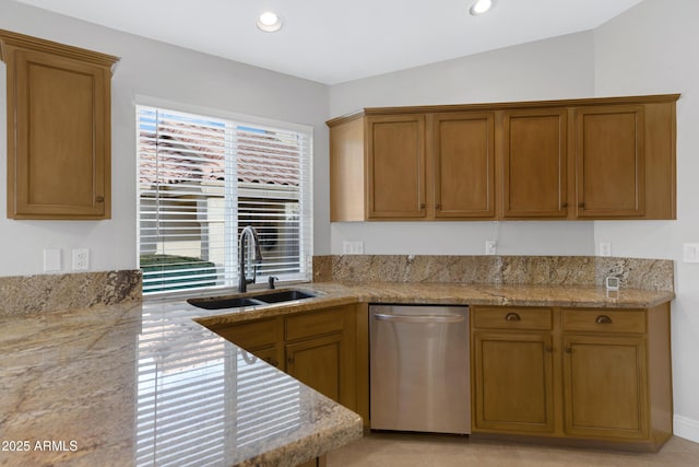 kitchen with dishwasher, sink, and light stone countertops