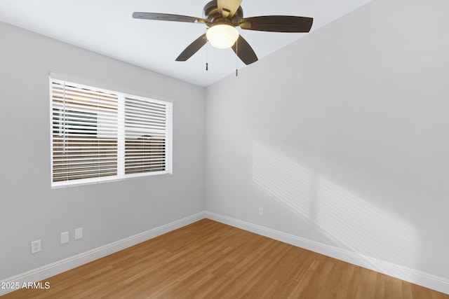 empty room with hardwood / wood-style floors and ceiling fan