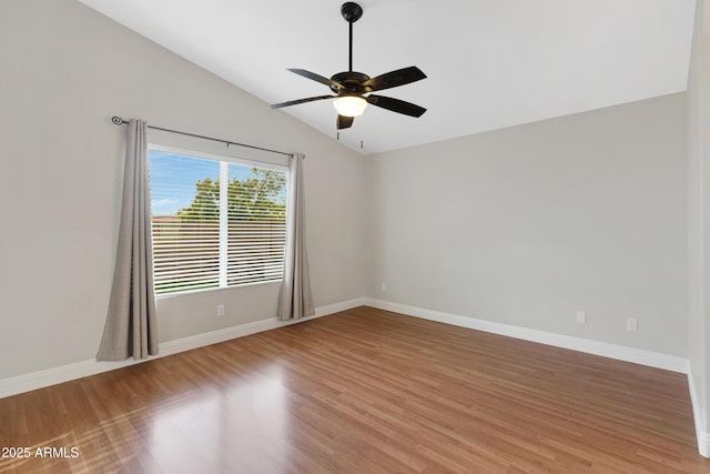 unfurnished room with lofted ceiling, hardwood / wood-style floors, and ceiling fan