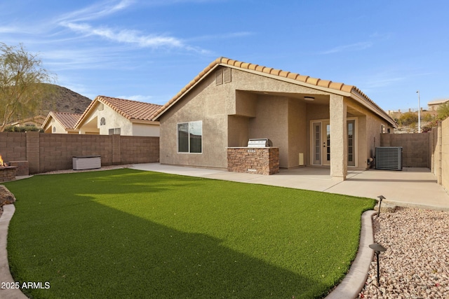 back of house with a patio, area for grilling, central AC, and a yard