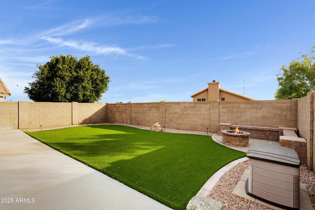 view of yard with a fire pit