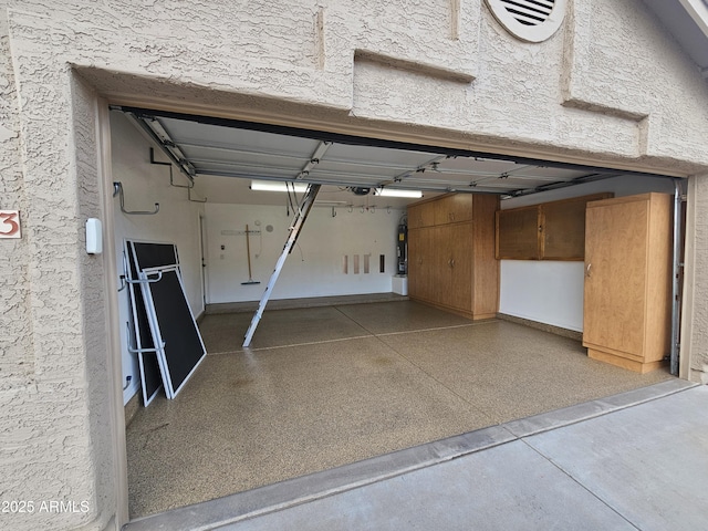 garage featuring water heater and a garage door opener