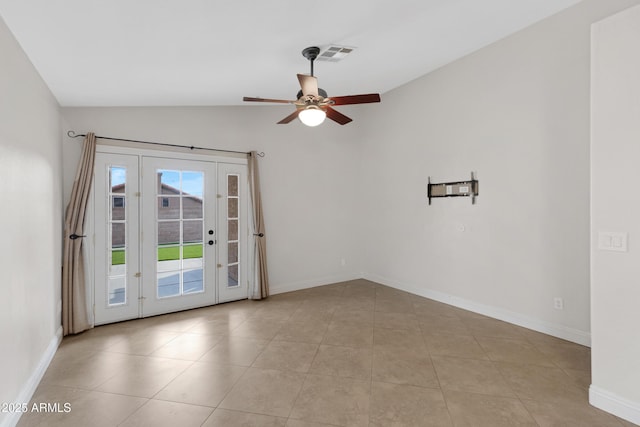 tiled empty room featuring lofted ceiling and ceiling fan