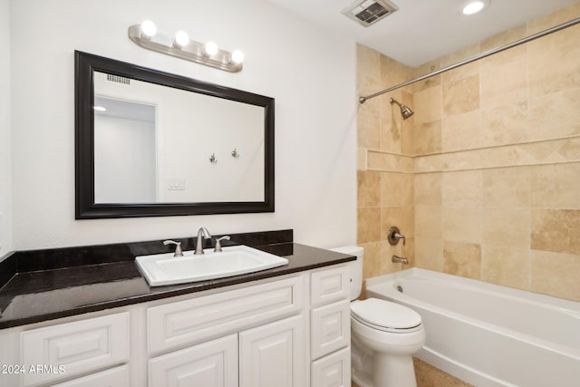 full bathroom featuring toilet, vanity, and tiled shower / bath