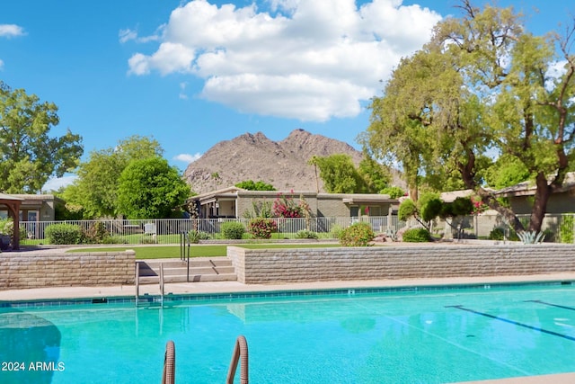 view of swimming pool with a mountain view