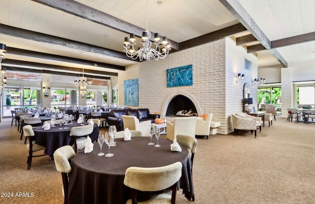 carpeted dining room featuring brick wall, a fireplace, beamed ceiling, and a notable chandelier