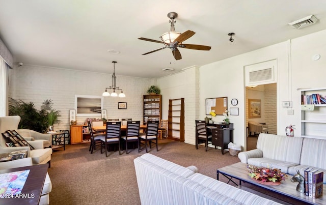 living room featuring ceiling fan and brick wall