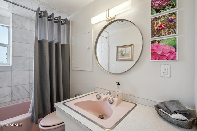 full bathroom featuring shower / tub combo, toilet, and sink