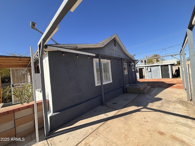 view of side of property featuring a patio