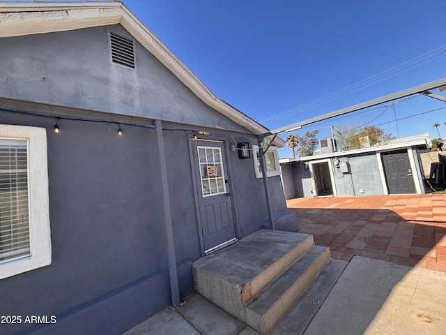 entrance to property with a patio area