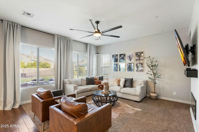 living room with wood-type flooring and ceiling fan