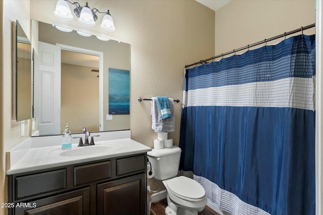 bathroom featuring vanity, hardwood / wood-style floors, a shower with curtain, and toilet