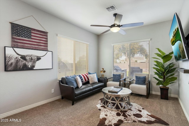 living room with ceiling fan and carpet flooring