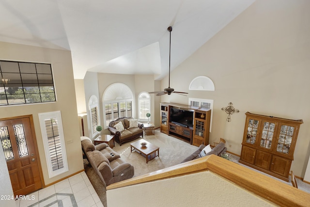 living room with light tile patterned floors, high vaulted ceiling, and ceiling fan