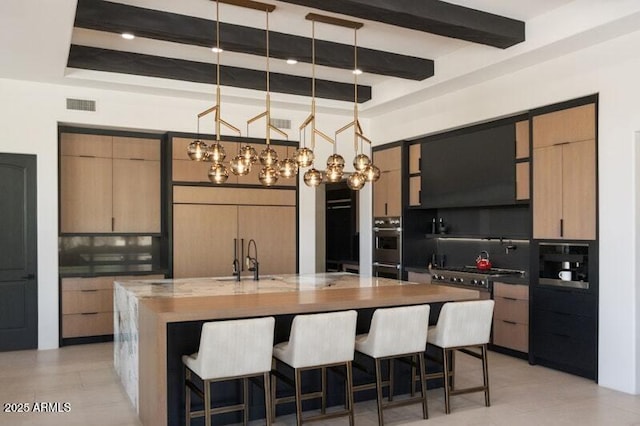 26285 N 89th St, Scottsdale, AZ 85255 - kitchen featuring a sink, modern cabinets, a kitchen breakfast bar, beam ceiling, and a large island with sink