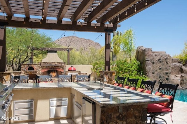 26285 N 89th St, Scottsdale, AZ 85255 - view of patio / terrace featuring an outdoor kitchen, a mountain view, and a pergola