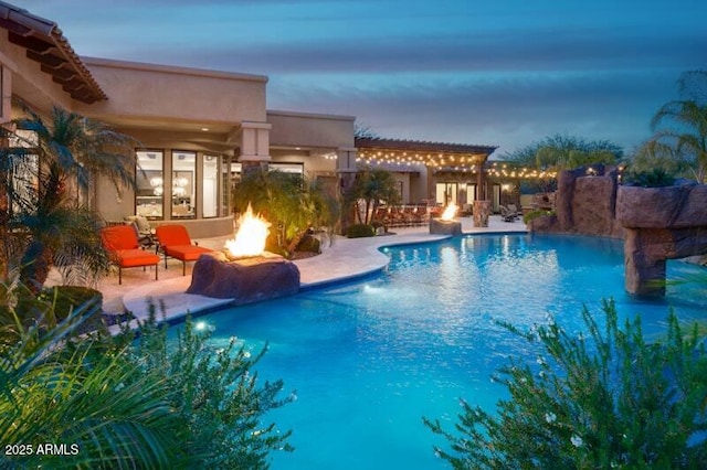 26285 N 89th St, Scottsdale, AZ 85255 - pool at dusk with a fire pit, a patio, and an outdoor pool