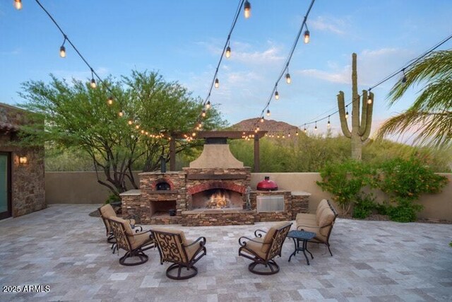 26285 N 89th St, Scottsdale, AZ 85255 - view of patio / terrace featuring an outdoor stone fireplace
