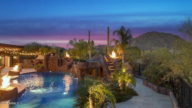 26285 N 89th St, Scottsdale, AZ 85255 - pool at dusk featuring an outdoor fire pit and a patio area