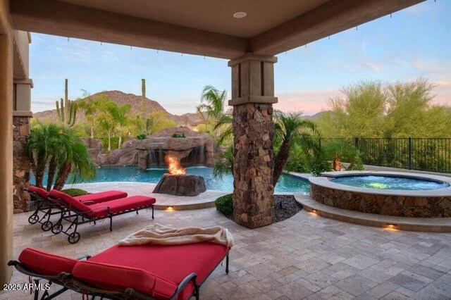 26285 N 89th St, Scottsdale, AZ 85255 - patio terrace at dusk with a patio, a mountain view, a pool with connected hot tub, and a fenced backyard