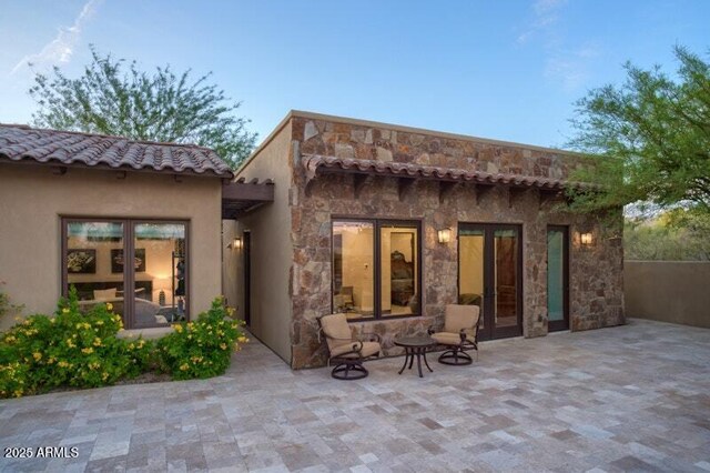 26285 N 89th St, Scottsdale, AZ 85255 - back of property featuring a patio, stone siding, stucco siding, and a tile roof