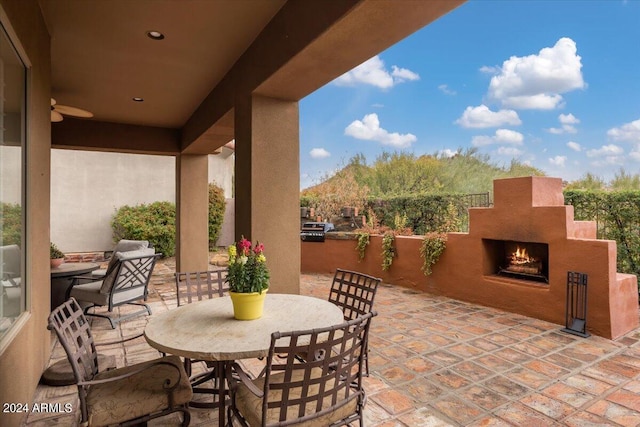 view of patio featuring exterior fireplace