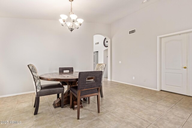 10001 W Potter Dr, Peoria, AZ 85382 - dining space with arched walkways, a chandelier, light tile patterned floors, baseboards, and a high ceiling