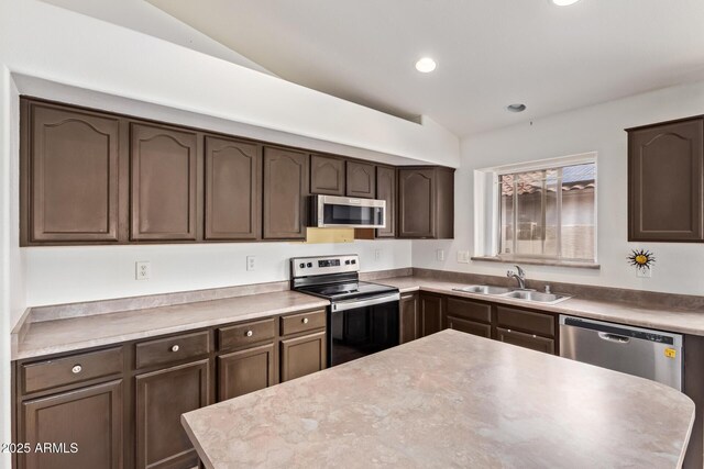 10001 W Potter Dr, Peoria, AZ 85382 - kitchen featuring stainless steel appliances, a sink, vaulted ceiling, dark brown cabinetry, and recessed lighting