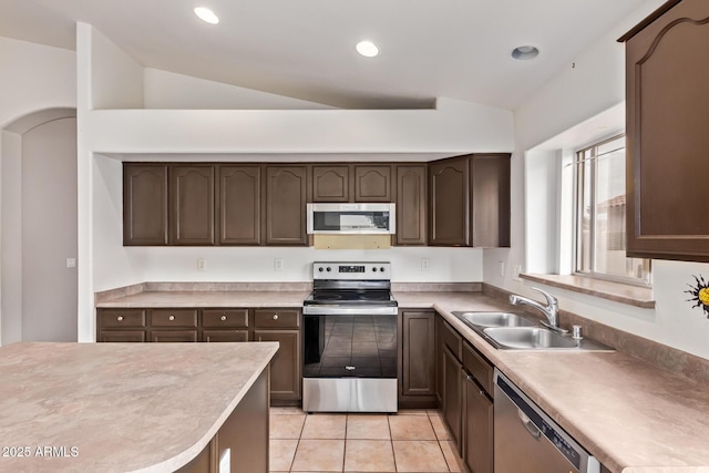 10001 W Potter Dr, Peoria, AZ 85382 - kitchen featuring appliances with stainless steel finishes, a sink, dark brown cabinetry, light countertops, and lofted ceiling